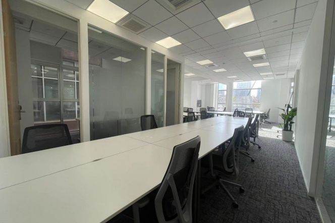 Fully Furnished 24-Person Office with Partitioned Spaces and Large Window