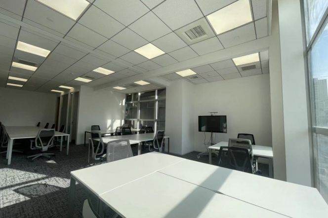 Fully Furnished 24-Person Office with Partitioned Spaces and Large Window