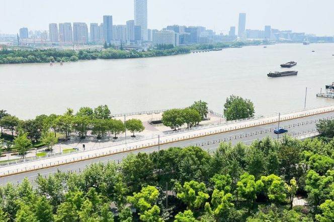 Shanghai Bay Phase 3, a luxury residence in Xuhui Riverfront area, featuring a view of the river.