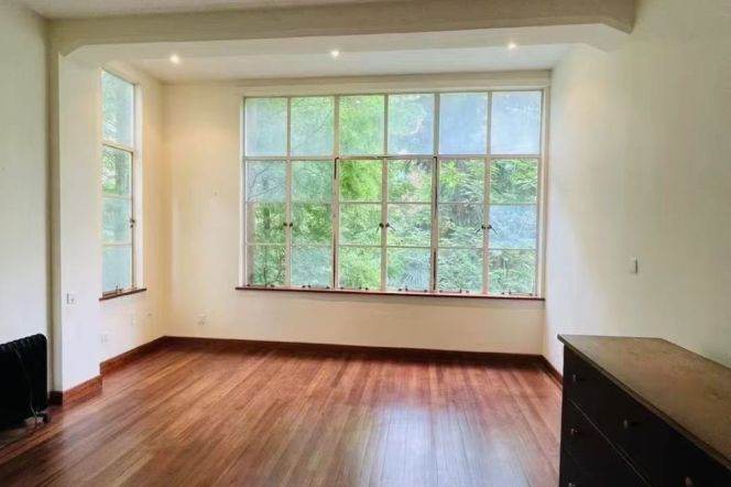 Absolutely stunning apartment, with three bedrooms, and windows offering views of greenery.