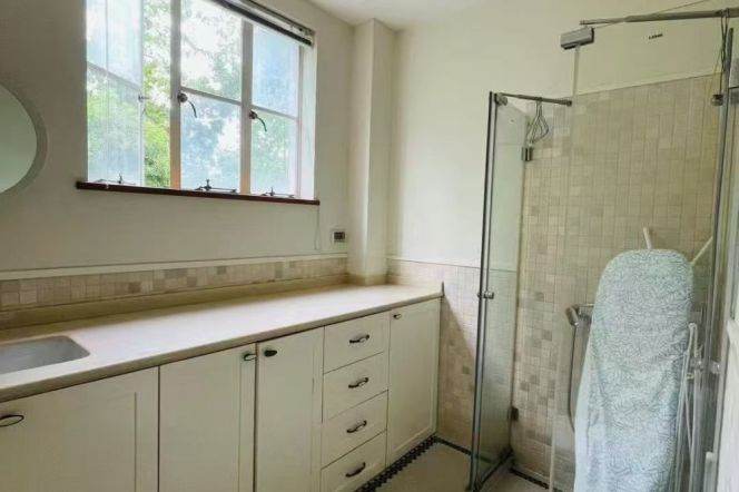 Absolutely stunning apartment, with three bedrooms, and windows offering views of greenery.