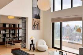Top-floor duplex on Suzhou River, with a private large terrace and a high-ceilinged living room.
